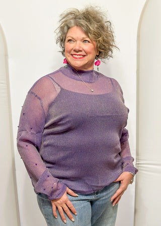 Long sleeve mock neck top with pearl accented sleeves in purple with gold metallic threads.