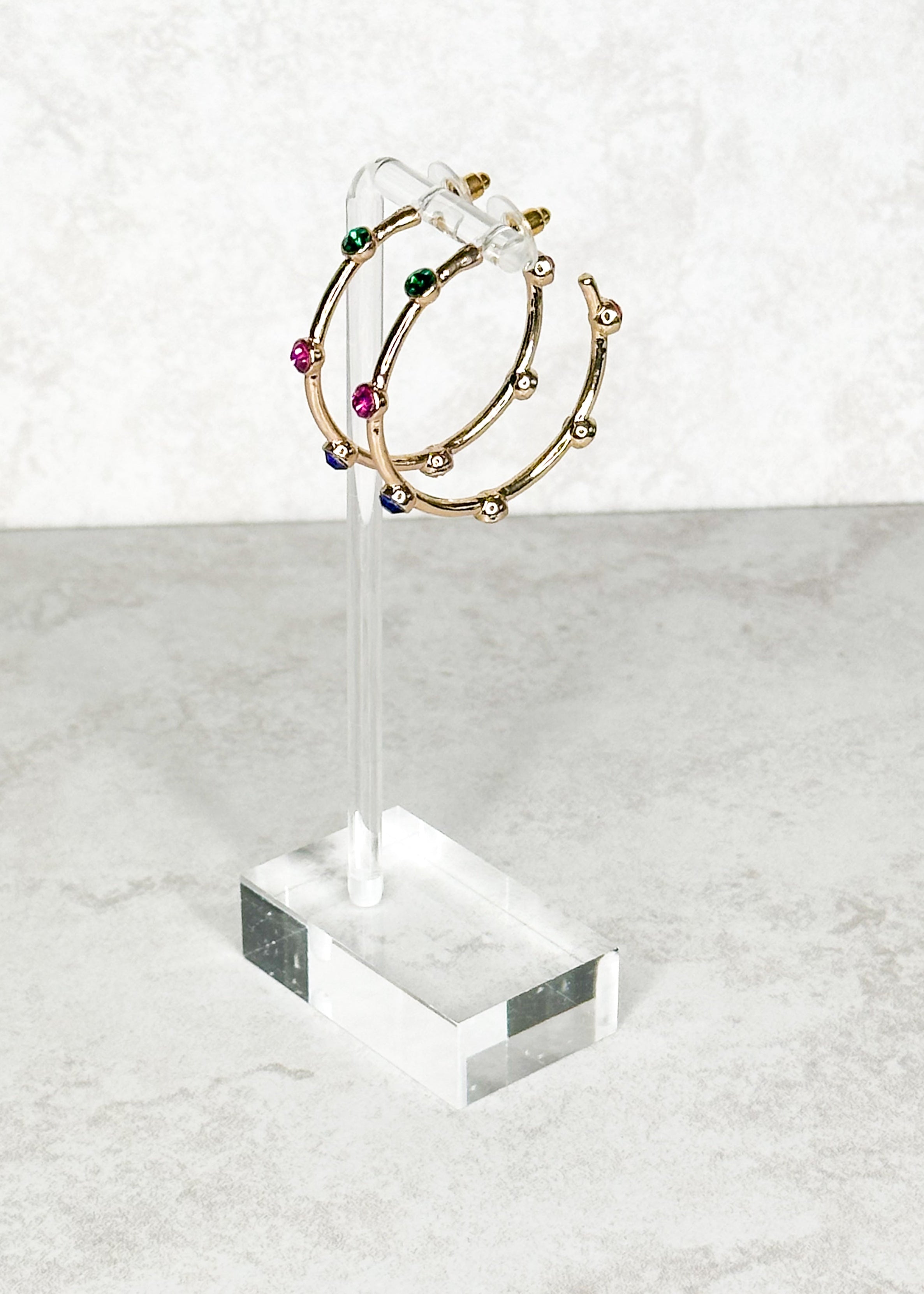 Gold with multi-colored jewels, open hoop, post back earrings.