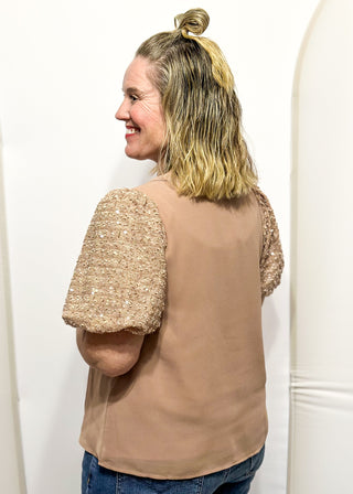 Rose-colored top featuring sparkly sequin puff sleeves and a relaxed, flowy body.