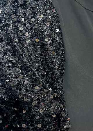 black top featuring sparkly sequin puff sleeves and a relaxed, flowy body.