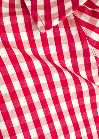 close up of gingham blouse with split neckline, collar, and 3/4 sleeves.