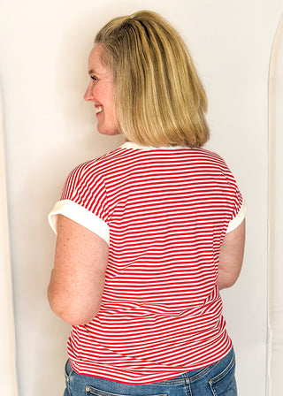 Red and white striped short sleeve top with white banding on sleeve and collar. 
