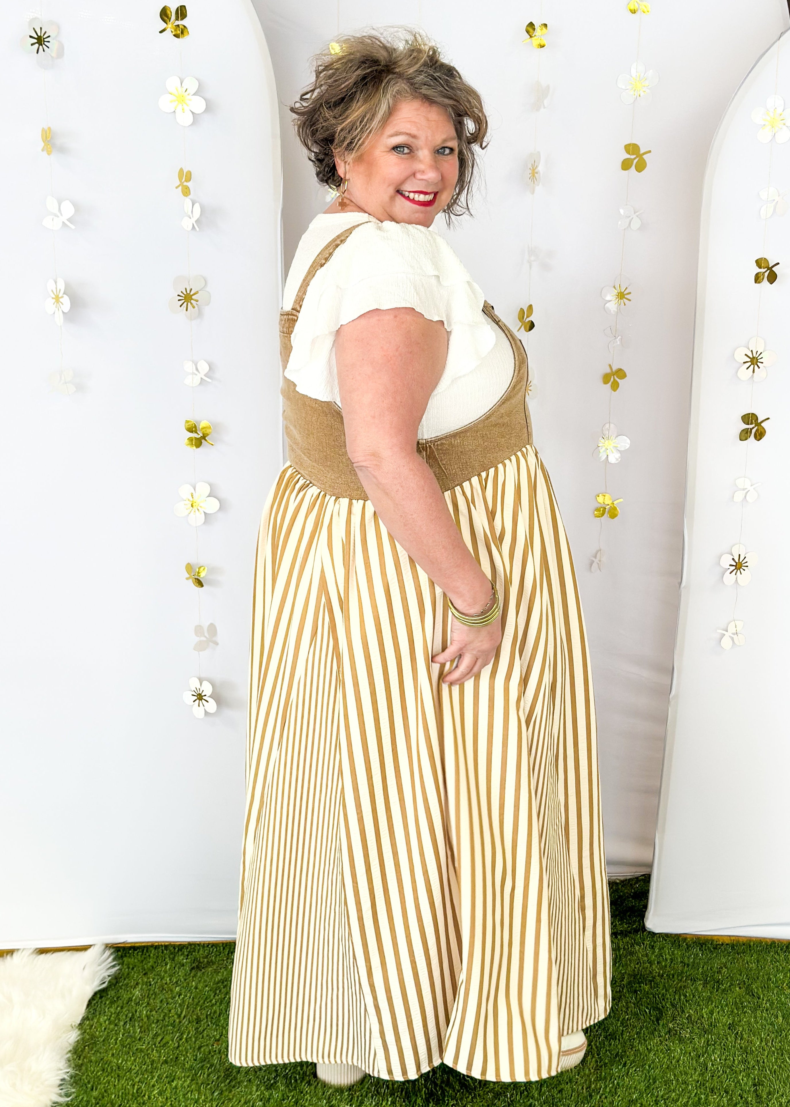 Maxi dress with pockets. brown vertical stripes on the bottom and brown denim overall top. Large front pocket and two buttons on either strap to adjust length.