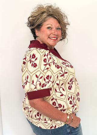 Neutral blouse featuring garnet florals with geometric hexagon pattern.