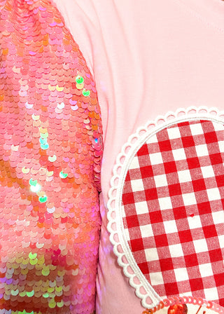 Sequin short sleeve top with 3 heart appliques.