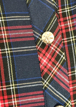 close up of navy plaid fabric and gold button detail