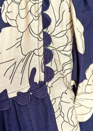 Navy blue fabric with beige floral patterns