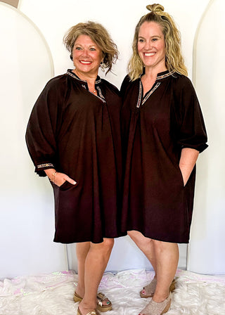 Solid black lightweight dress with v-neck and 3/4 length sleeve. Leopard lace detail on the sleeves, collar and v-neck.