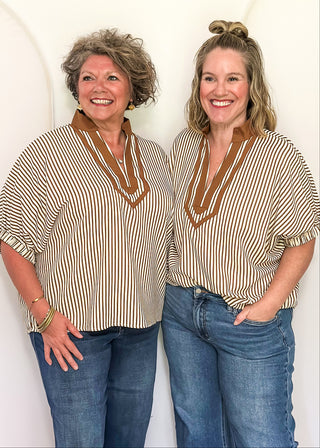 Model wearing the Dolman Striped Brown Top featuring a relaxed fit, classic stripe pattern, and contrasting trim details.