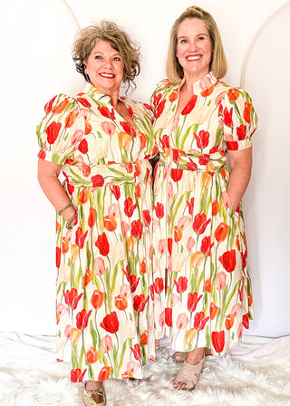 Tulip print midi dress with short sleeves, smocked waist, pockets, and lined fabric