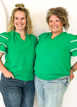 Kelly Green puff sleeve top- 3 tiered white rick-rack Trim on sleeves-
Ruffle Collar, V-neck.  