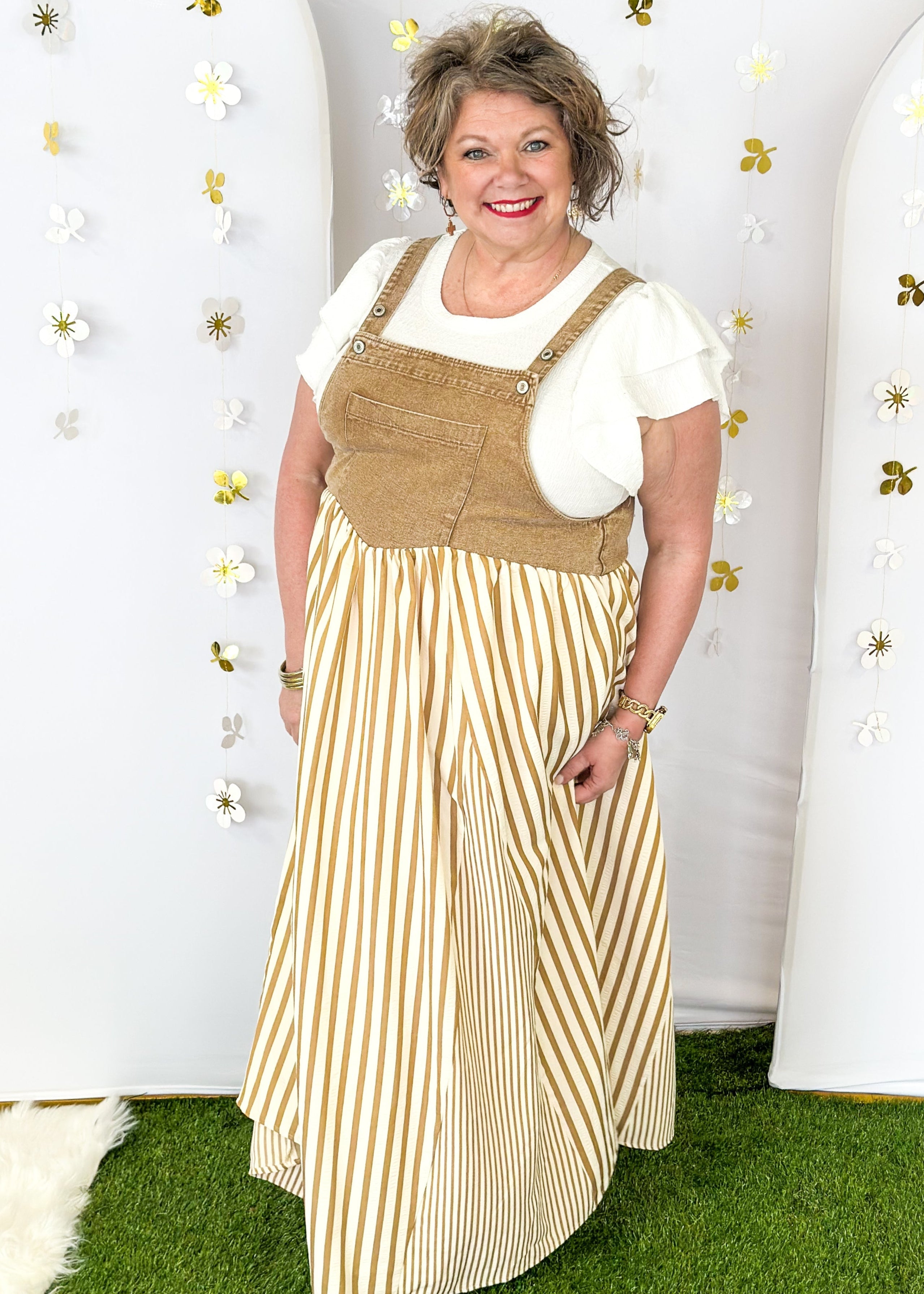 Maxi dress with pockets. brown vertical stripes on the bottom and brown denim overall top. Large front pocket and two buttons on either strap to adjust length.