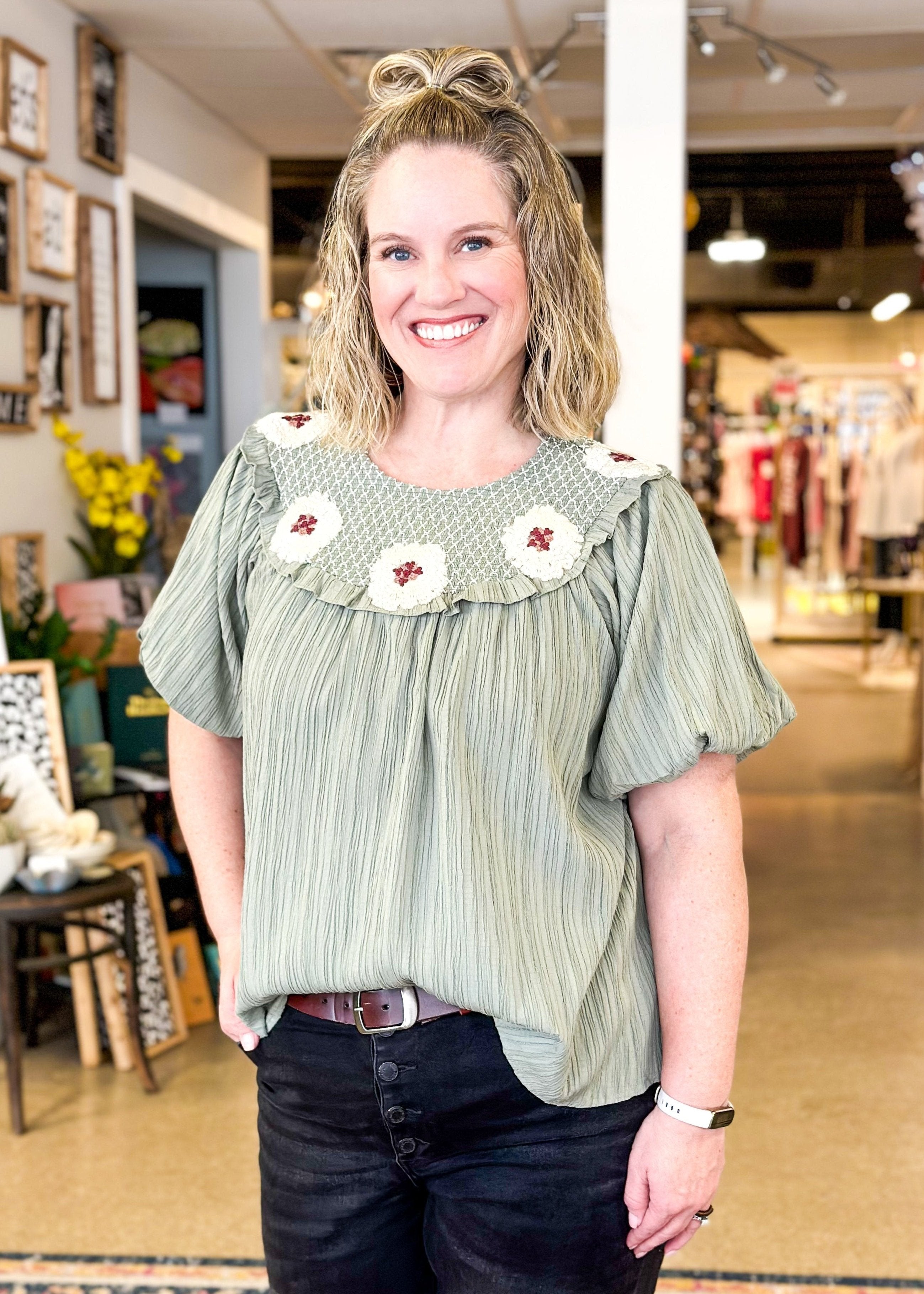 sage green crepe like flowy top with puff sleeve - crochet flowers around the top 