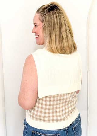 Sleeveless green checkered sweater with faux wrap in cream.