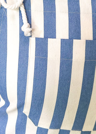Blue and white striped shorts romper with front pocket and back pockets with heart cut out. 