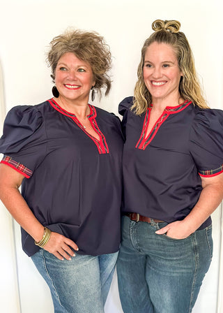 Puff sleeve navy top with red plaid contrast on the sleeve and v-neck.																									