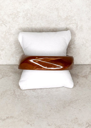 Brown Bangle bracelet displayed on a stand 