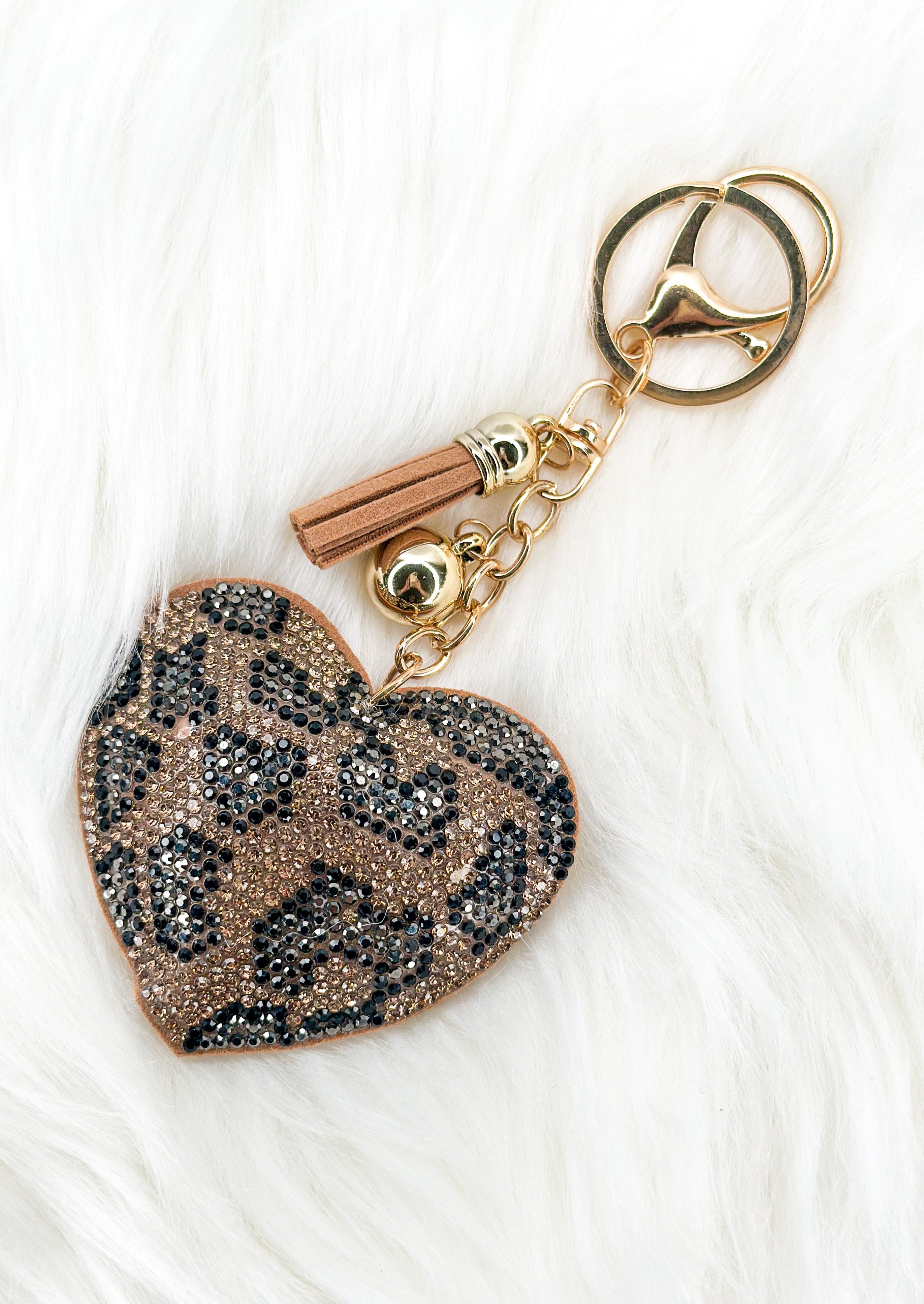 Leopard heart sparkly keychain with gold tassel and hardware.