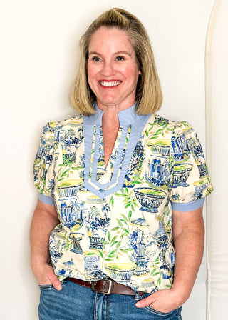 Blue and green botanical print top with contrast neckline and relaxed fit.