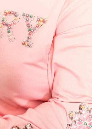 Light pink long sleeve top with beaded ‘MERRY’ lettering across the chest and sequin and beaded snowflakes on the sleeves. 