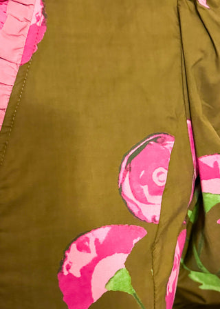 pink florals on brown long sleeve top with shades of pink ruffle around collar and down the front - button up