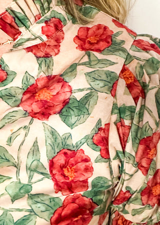 Light Pink short sleeve top, v-neck with ruffle detail.  Elastic detail on the sleeve.  Large Rose pattern with jade leaves. 
