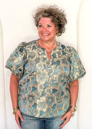 woman in jacquard floral puff sleeve top in Gold Marine.