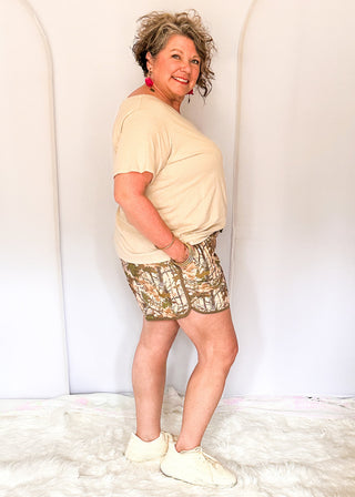 Camo print athletic shorts with dark green trim