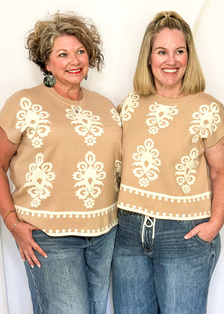 Taupe knit sweater with ivory woven pattern and short sleeves.