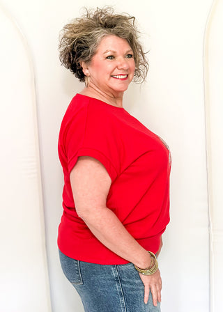 Red short sleeve top with 2 sequin firework bursts.