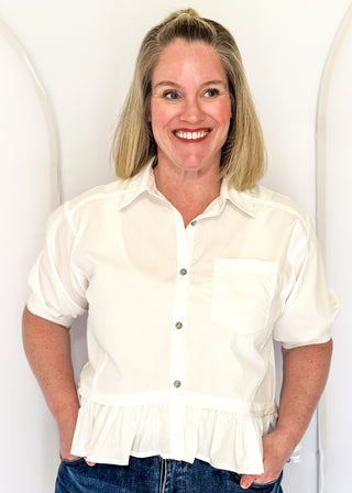 White button-up top with ruffle hem, short sleeves
