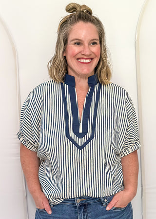 Model wearing an indigo-colored Entro dolman striped top with contrast trim, styled in a relaxed, casual fit.