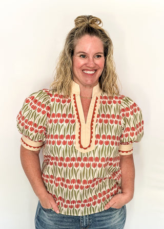 Large puff sleeve top with terracotta tulips and green leaves.  Contrast is ecru with terracotta scallop detail-short sleeve and v-neck.