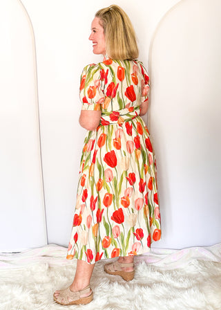 Tulip print midi dress with short sleeves, smocked waist, pockets, and lined fabric