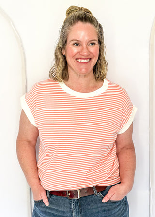 Coral and white stripe short sleeve top with white contrast banding on the collar and sleeves. 