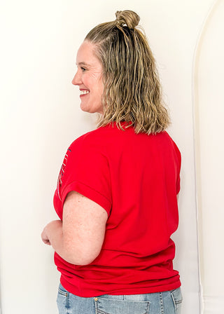 Red short sleeve top with 2 sequin firework bursts.