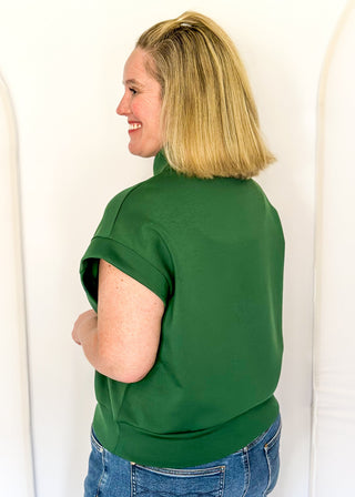 Green scuba fabric athleisure top with zip detail and modern silhouette