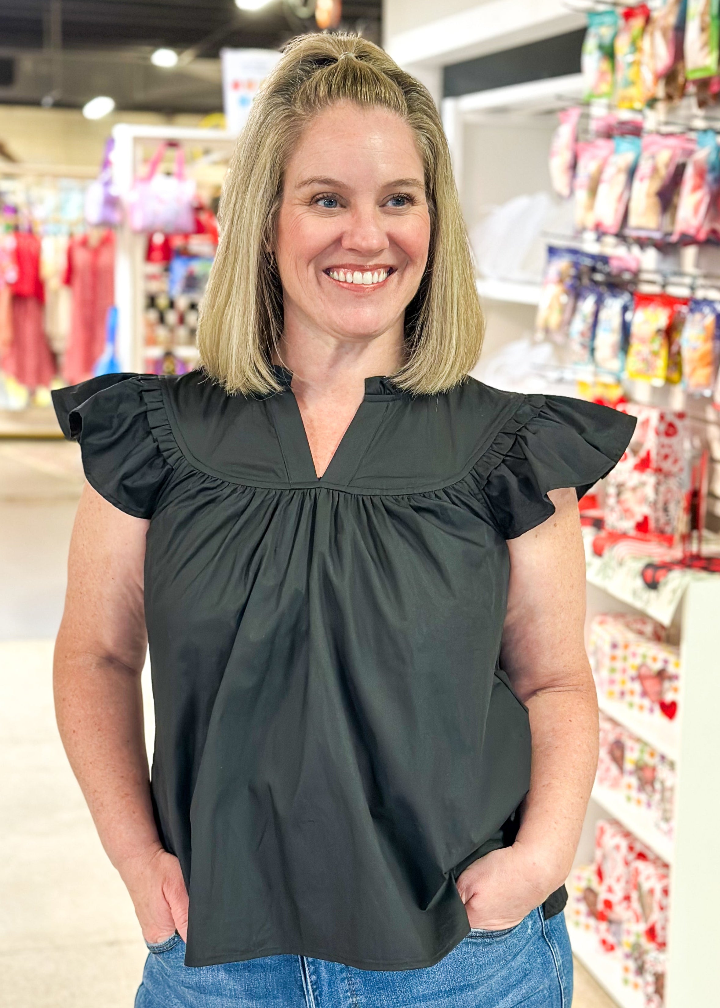 notched v-neck ruffle short sleeve top with ruffle neck and seam above the chest - black