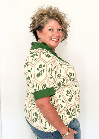 Neutral blouse featuring green florals with geometric hexagon pattern
