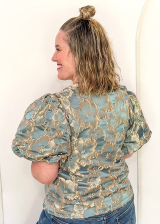 woman in jacquard floral puff sleeve top in Gold Marine.