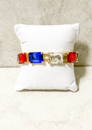 Red, Blue and Clear Jeweled stretchy bracelet with gold beading.