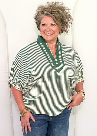 Model wearing a Hunter Green-colored Entro dolman striped top with contrast trim, styled in a relaxed, casual fit.