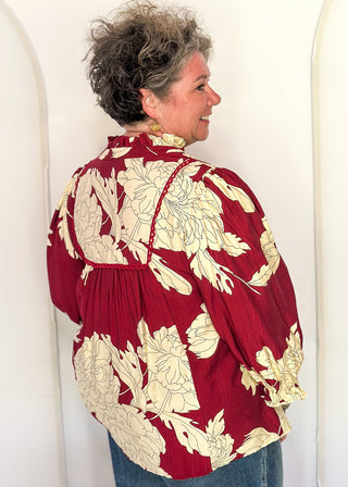 woman in longsleeve burgundy floral top