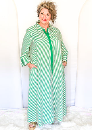 Green vertical striped collared dress with button-down front with green contrast, 3/4 sleeves, midi length, and side pockets.