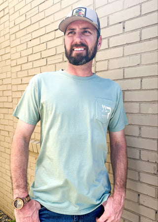 light sage green tee shirt with different types of ducks as the graphic on the back and ROOST - southern waterfowl words on the back - front pocket