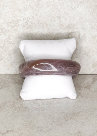 Grey Bangle bracelet displayed on a stand 