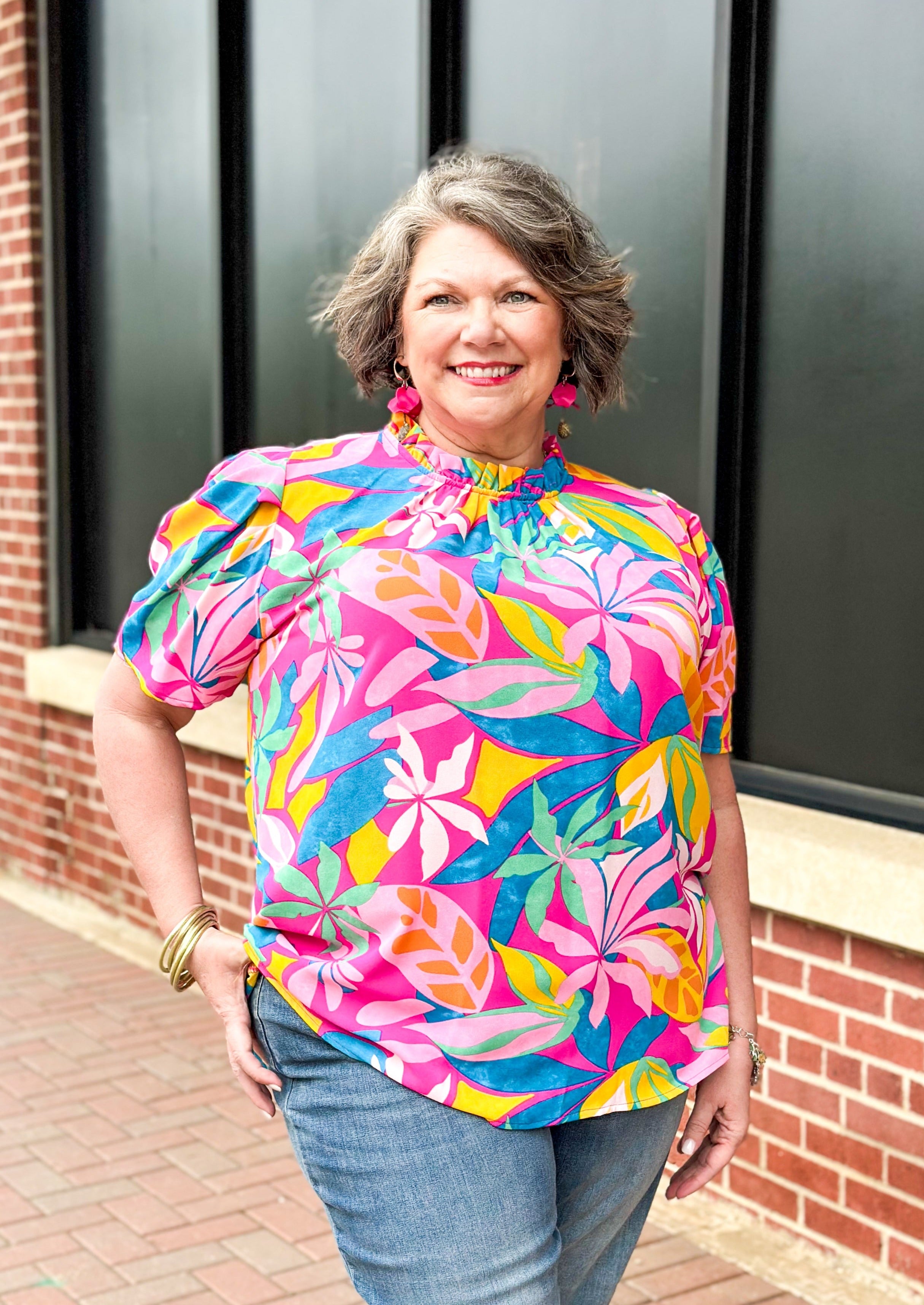 bright tropical bring on pink short sleeve top with ruffle neck and bubble type sleeve