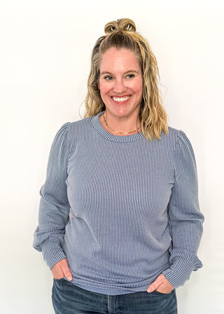 long sleeve ribbed top with cuff sleeve and small puff detail in shoulder. crew neck. 