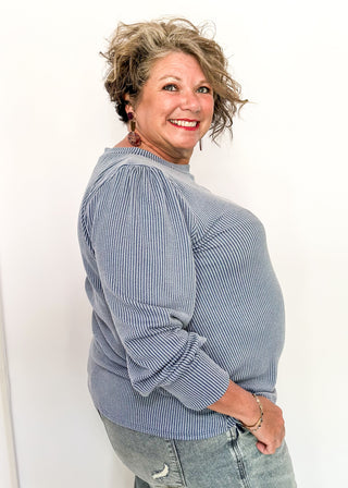 long sleeve ribbed top with cuff sleeve and small puff detail in shoulder. crew neck. 