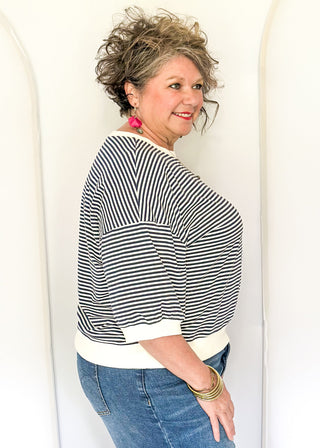 Striped knit dolman top with crew neckline and ribbed trim in red.